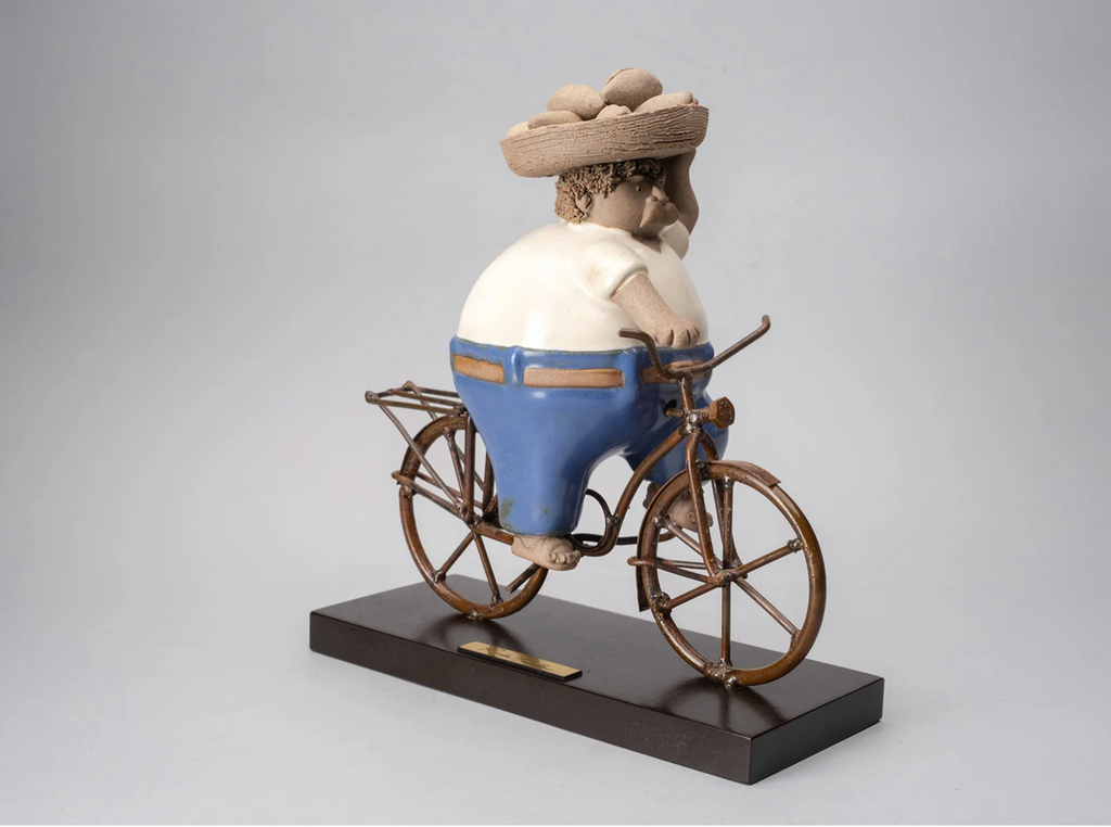 Handmade ceramic sculpture by Rodo Padilla of a baker riding a bicycle with bread – 10.6 x 3.5 x 9.4  inches – Mexican folk art honoring everyday workers and traditional trades.
