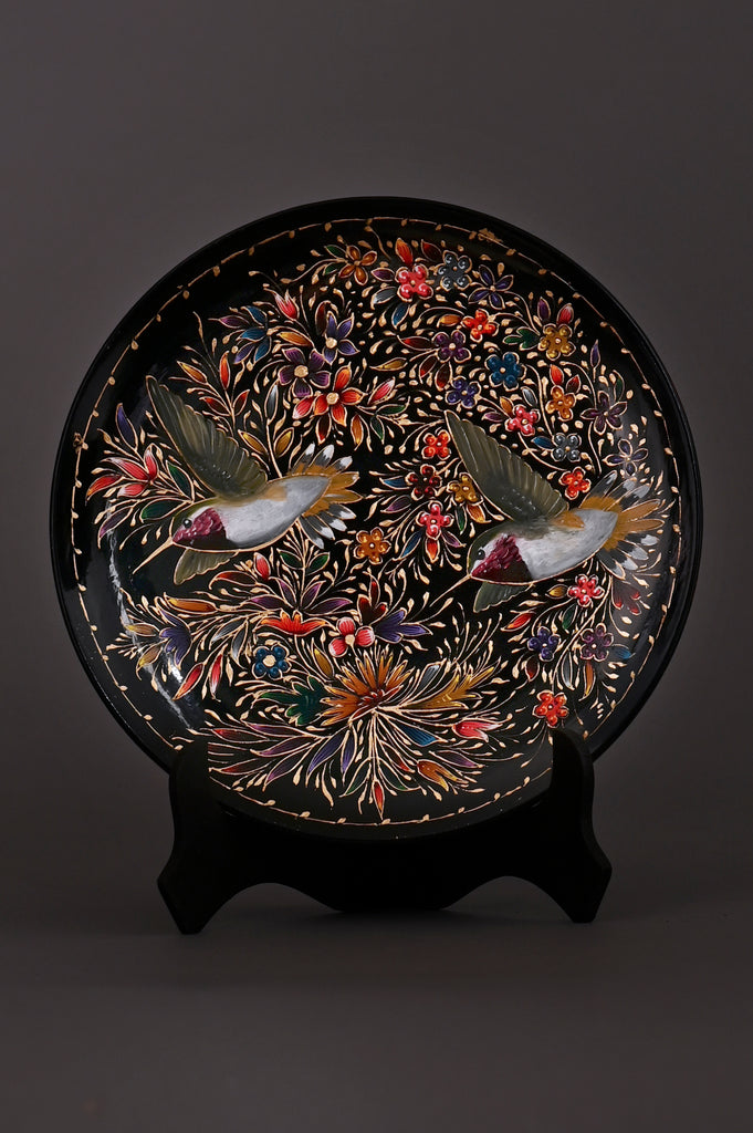 Hand-painted Mexican decorative plate with hummingbirds and colorful floral design on black background, crafted by artisans in Pátzcuaro, Michoacán