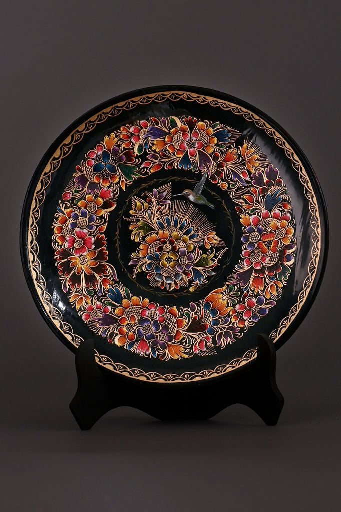 Discover the Mockingbird & Floral Harmony Hand-Painted Mexican Decorative Plate. Crafted from lacquered wood, this artisan masterpiece celebrates vibrant Mexican folk art and nature’s beauty. Authentic Mexican art. Traditional art. Made in Pátzcuaro, Michoacán, Mexico.
