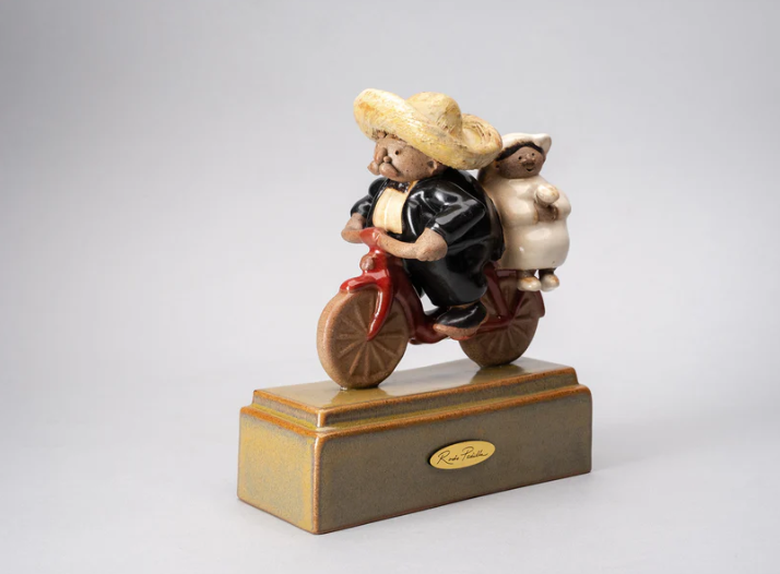 Handmade ceramic sculpture by Rodo Padilla of newlyweds riding a bicycle – 7.1 x 2.4 x 5.9 inches – romantic Mexican folk art perfect for weddings, anniversaries, or love-filled spaces.