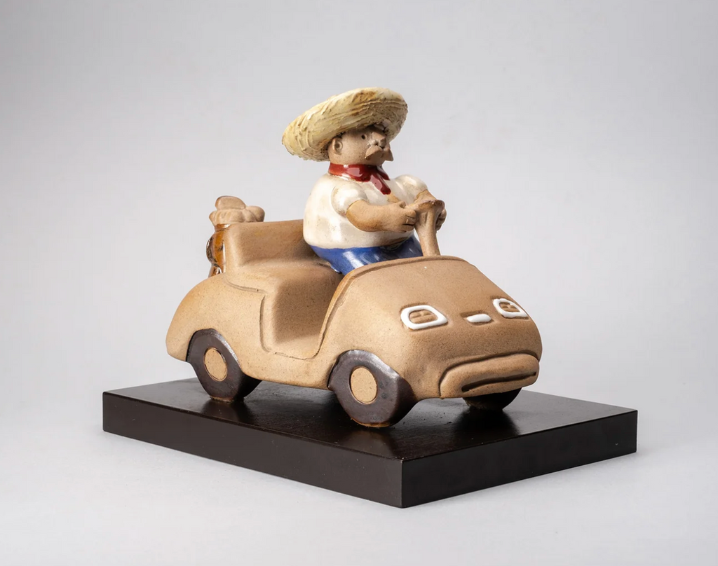 Guy in a Golf Cart ceramic sculpture by Rodo Padilla featuring a charming figure riding in a golf cart, handmade in Tlaquepaque, Mexico.
